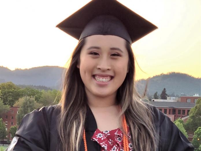 Karen Nguyen wearing graduation gown during sunset on OSU Corvallis campus.