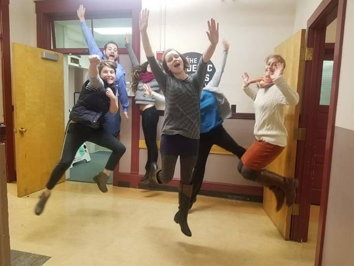 The Academic Success Center team jumping in hallway.