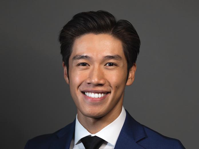 Daniel Trinh, a man with short black hair in a suit. 