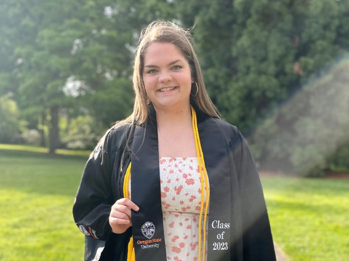 Kennedi Waldrop wearing her commencement gown and tassels.