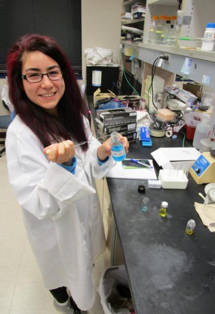 Marissa Gallegos checking out samples in lab