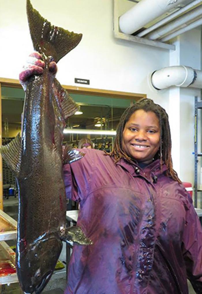 Nicole Hams holding salmon in lab