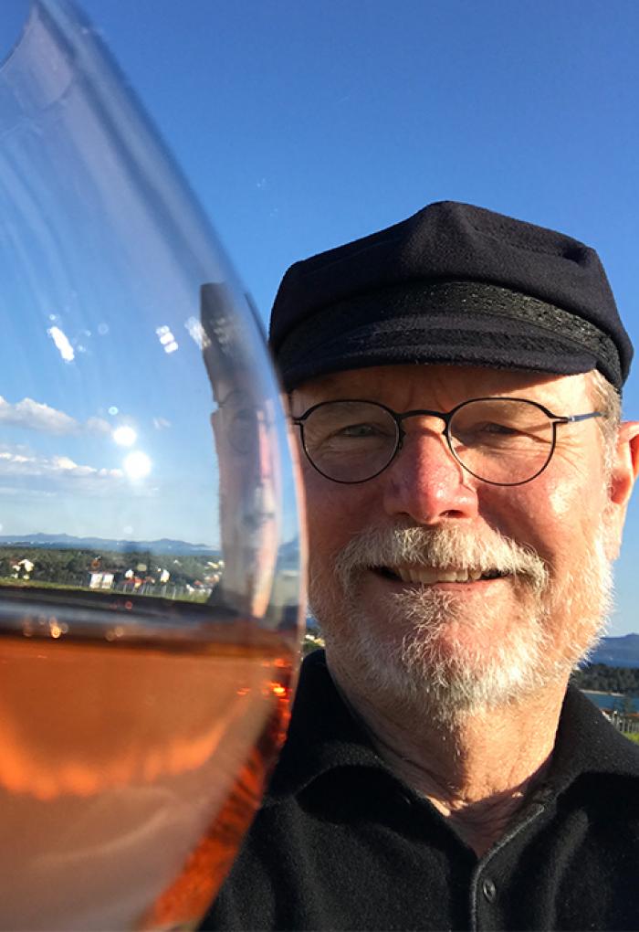 Joel Peterson taking selfie with wine glass