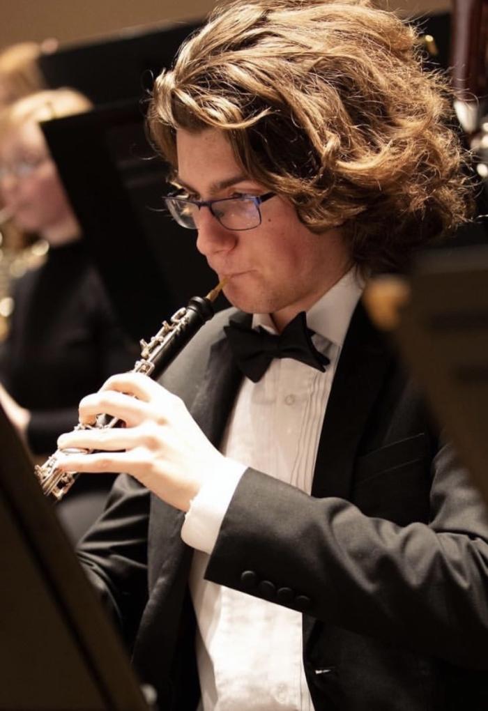Bailey-Darland plays the oboe during an orchestra performance.