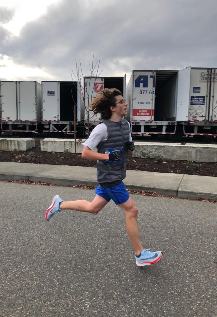 Bailey-Darland running in a half-marathon during an overcast day.