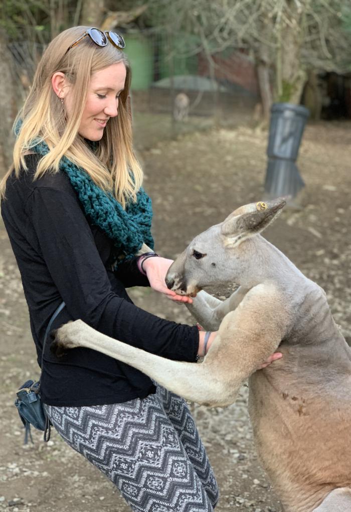 Karianna Crowder smiles as she greets a kangaroo.