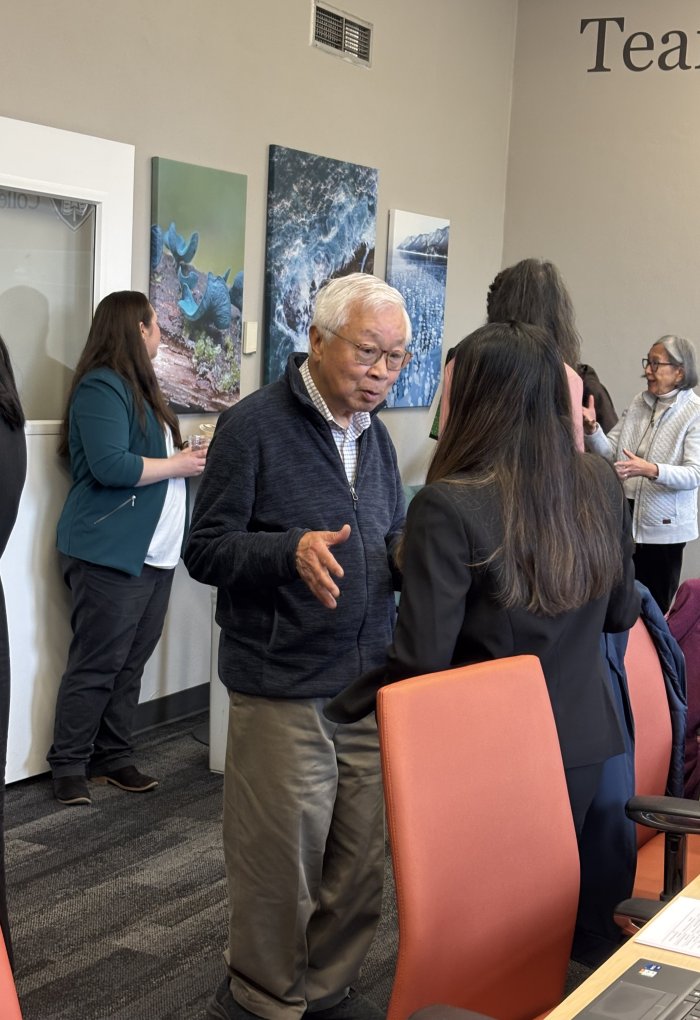 People talk in a conference room.
