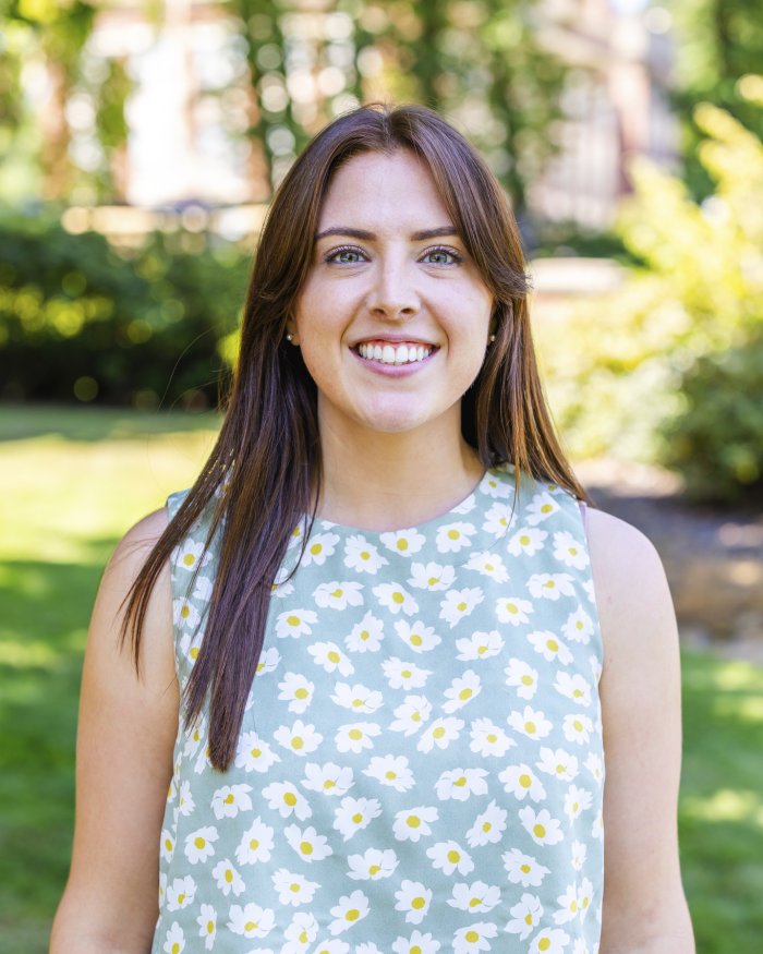 A photo of Rachel Palmer who has long brown hair, green eyes, and is smiling