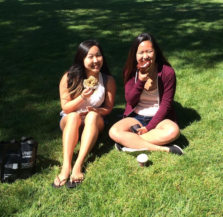 female students sitting in grass outside Valley Library