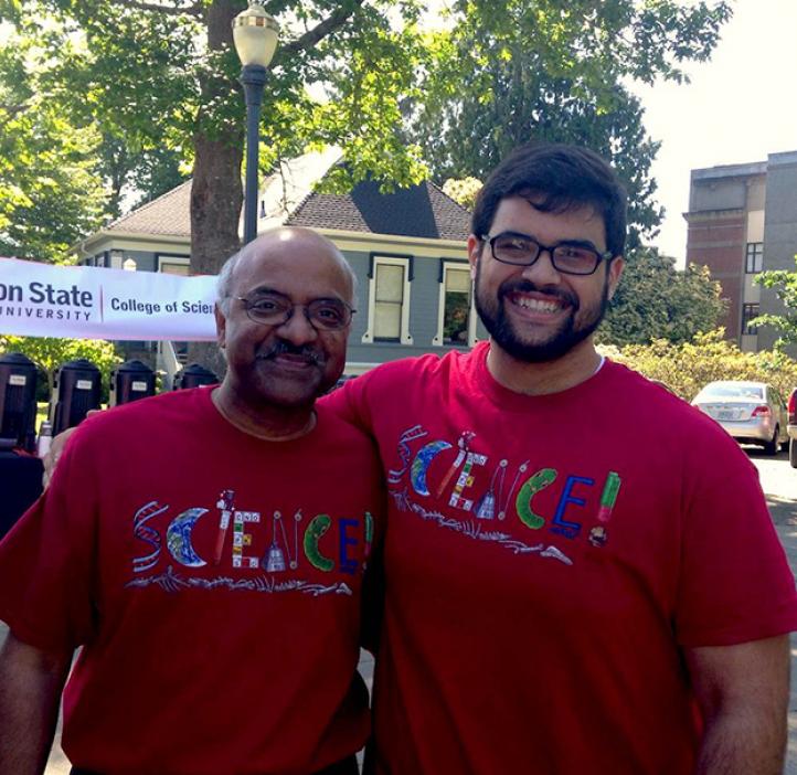 Sastry Pantula and colleague in red t-shirts in front of science club booths outside Milne Hall