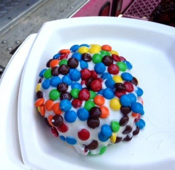 M&M coated donut on white plate