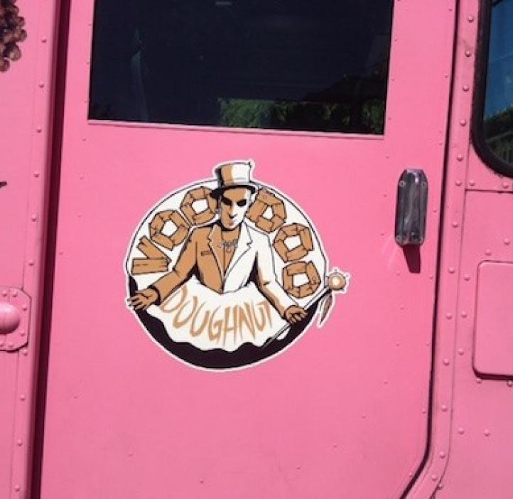 pink delivery truck with Voodoo Doughnut logo