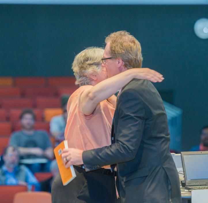 Corinne Manogue hugging Roy Haggerty on stage