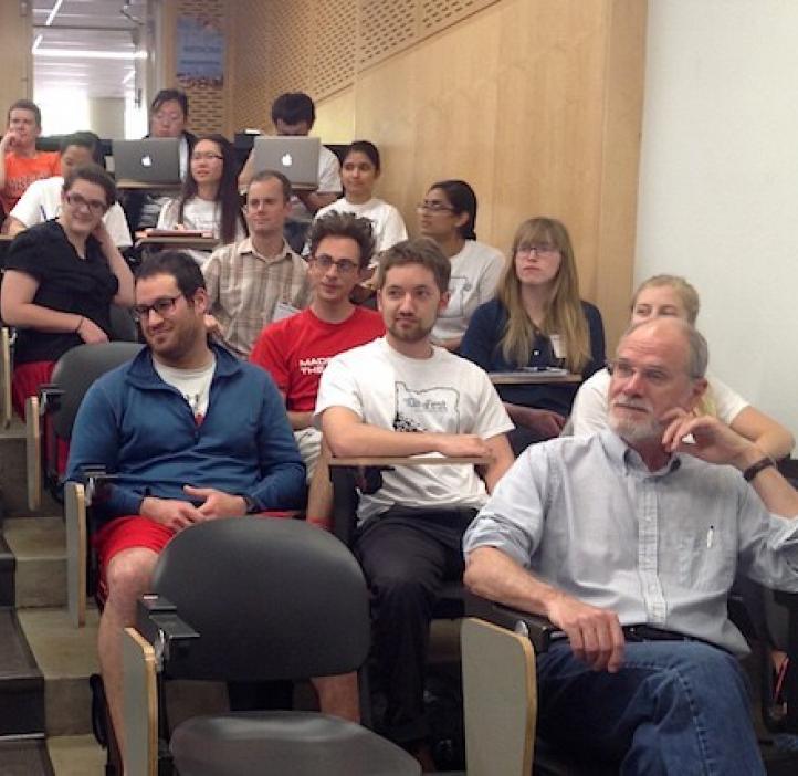 faculty and students sitting in lecture hall