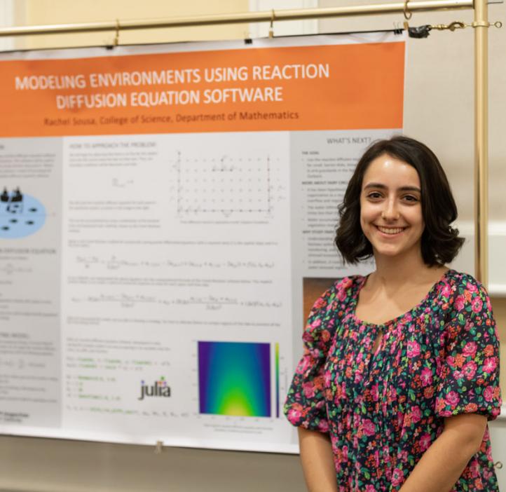Rachel Sousa standing next to her research poster