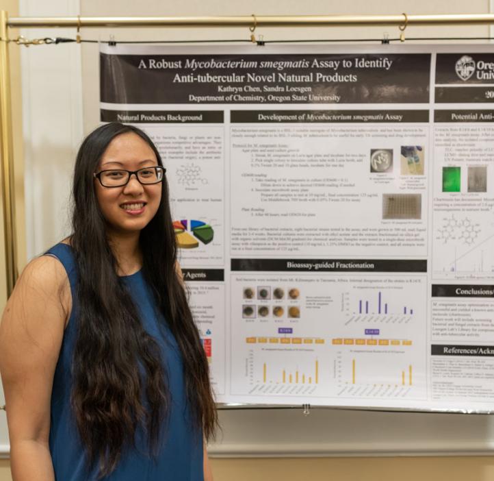 Kathryn Chen next to research poster