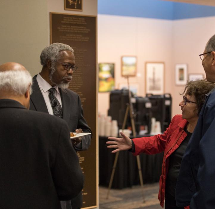Sylvester James “Jim” Gates, Jr. chatting with colleagues in lobby