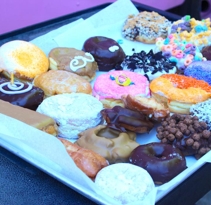 decorated doughnuts sitting on tray