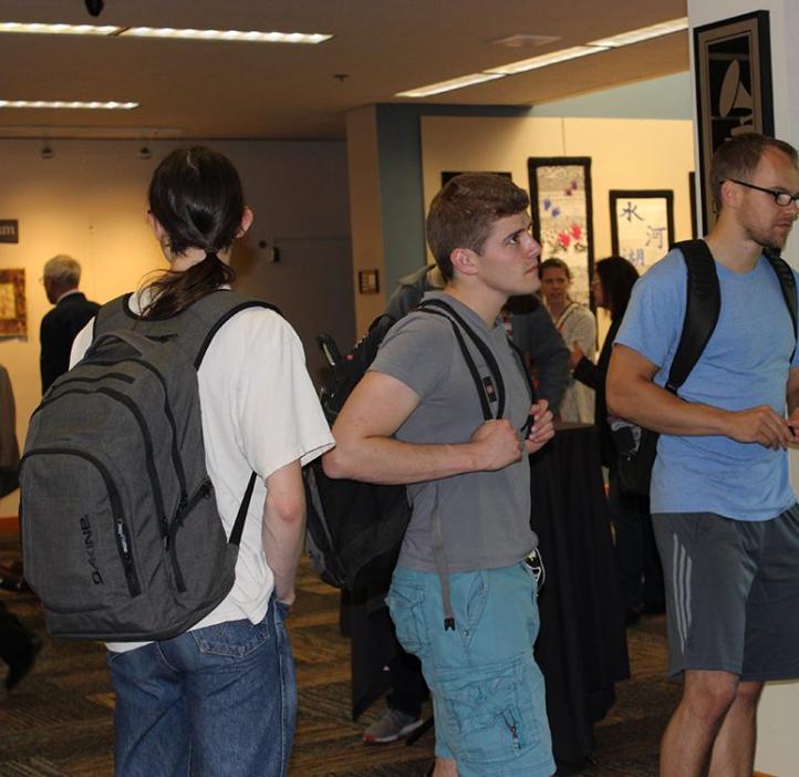 male students walking around lobby