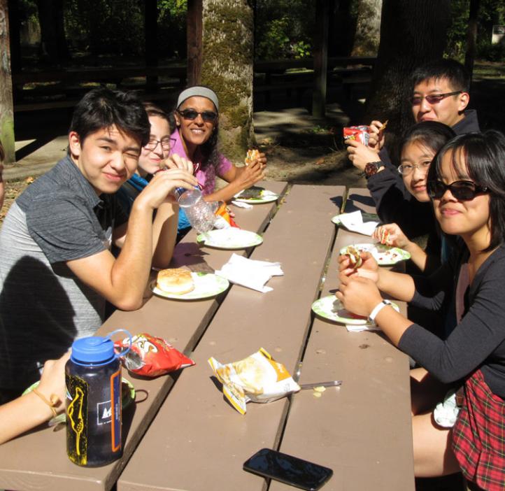 Indira Rajagopal with science students at picnic table