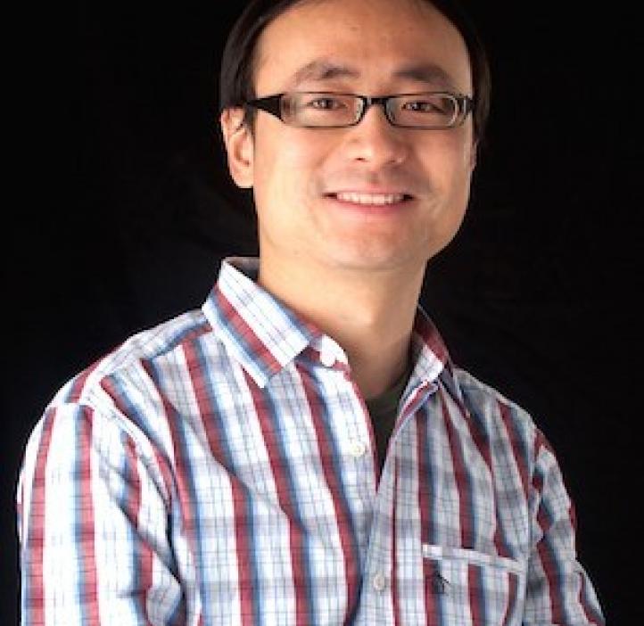 Chong Fang, Chemistry professor in front of black backdrop