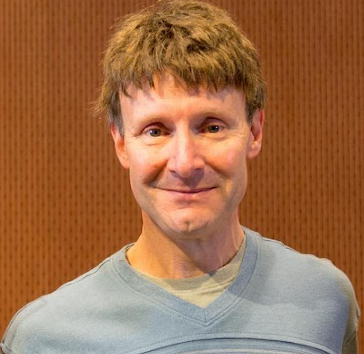 Jeffrey Kollath, Statistics professor in front of wood backdrop