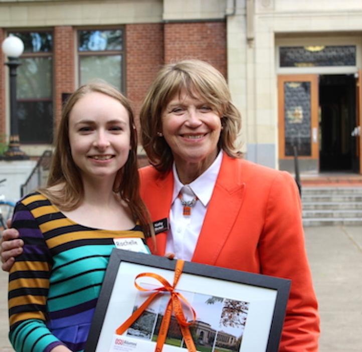 Rochelle Glover with Kathy Bickel holding frame in front of Kidder Hall