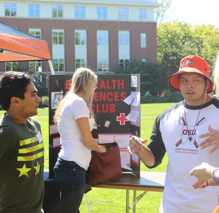 science students explaining their club booth