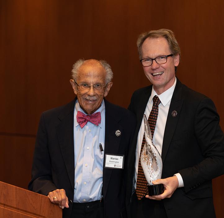 Roy Haggerty standing with distinguished alumnus Warren Washington