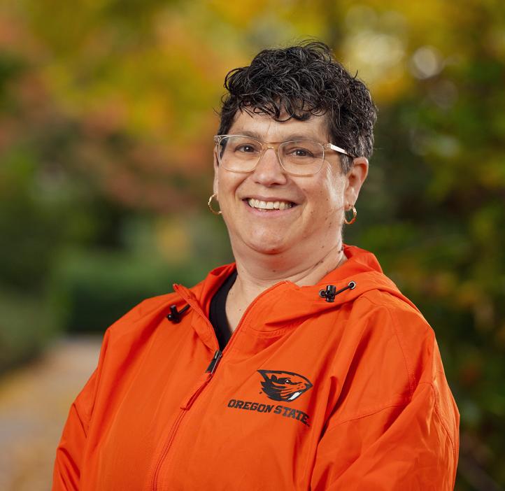 Dean Eleanor Feingold smiling in orange Oregon State jacket