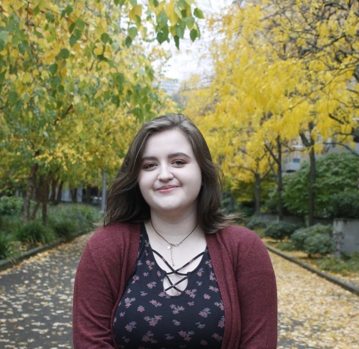 Headshot of a woman in black shirt and maroon sweater