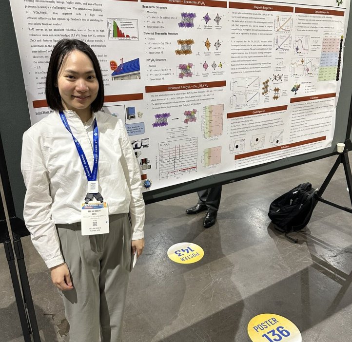 A grad student poses next to their research paper at the 2025 American Chemistry Society national conference.