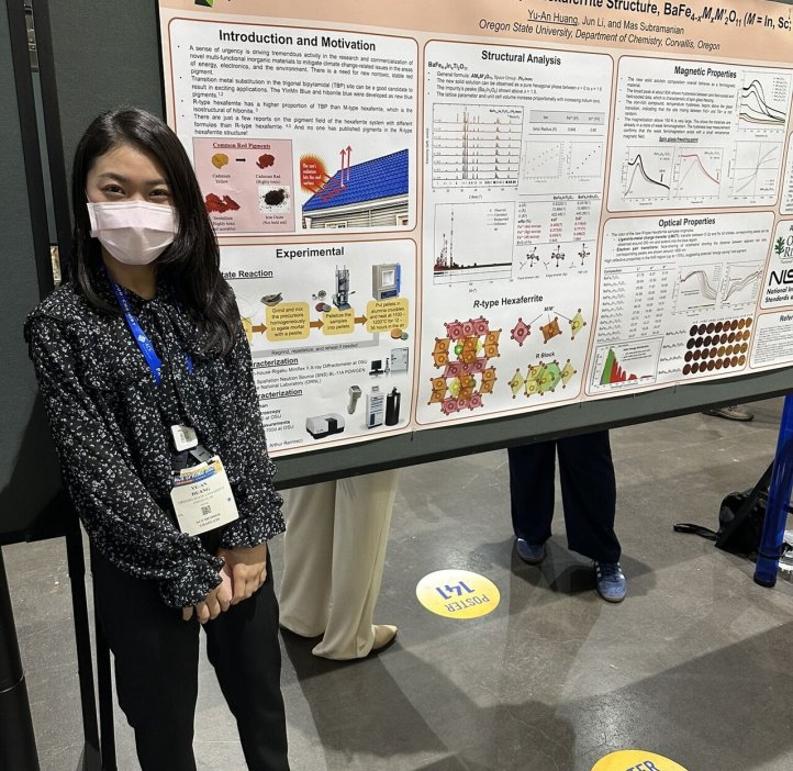 A grad student poses next to their research paper at the 2025 American Chemistry Society national conference.