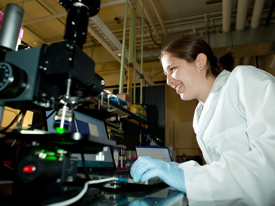 Student working with Genome research machinery
